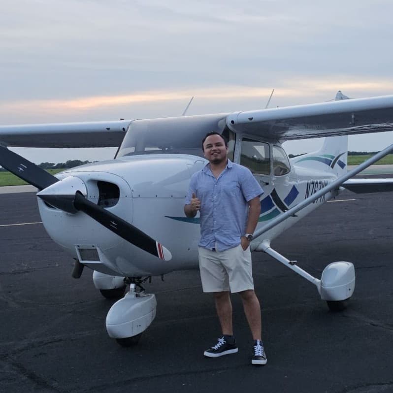 Portrait of Martin Wnorowski in from of single-engine plane